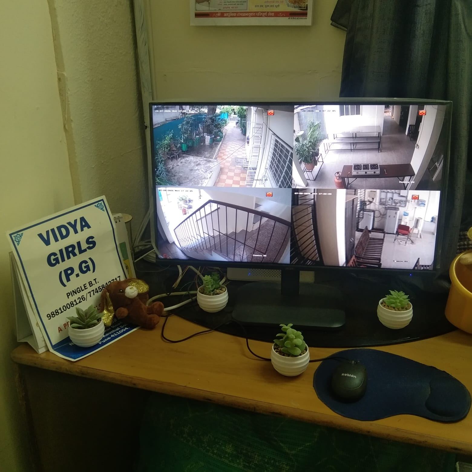 CCTV security monitor covering common areas at Vidya Girls PG